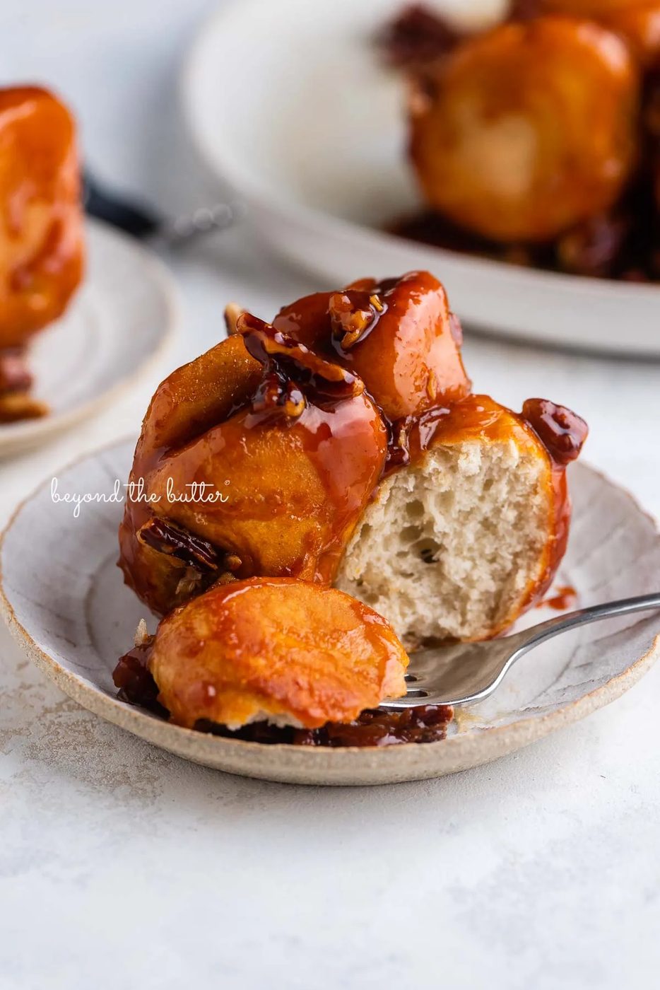 Individual plate of partially eaten butterscotch rolls on a white background | © Sovuh