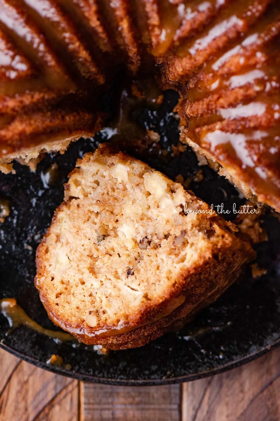 Slice of house-made apple bundt cake on it's side on black plate | © Sovuh