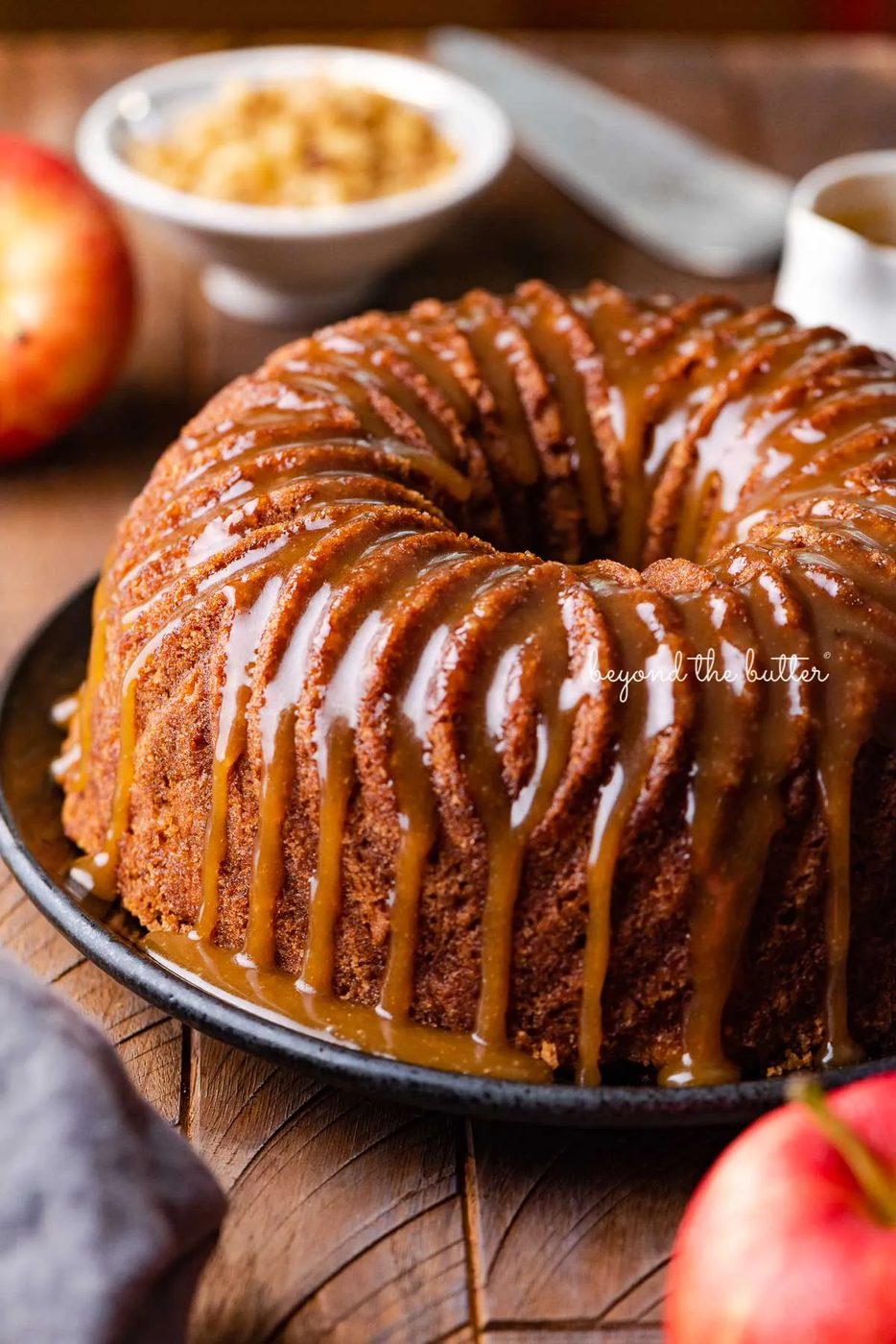 House-made apple bundt cake with brown sugar glaze on dark wood background | © Sovuh