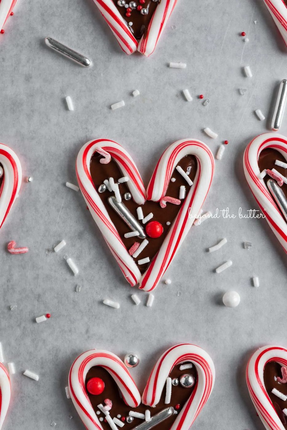 Fun candy cane hearts on parchment paper | © Sovuh