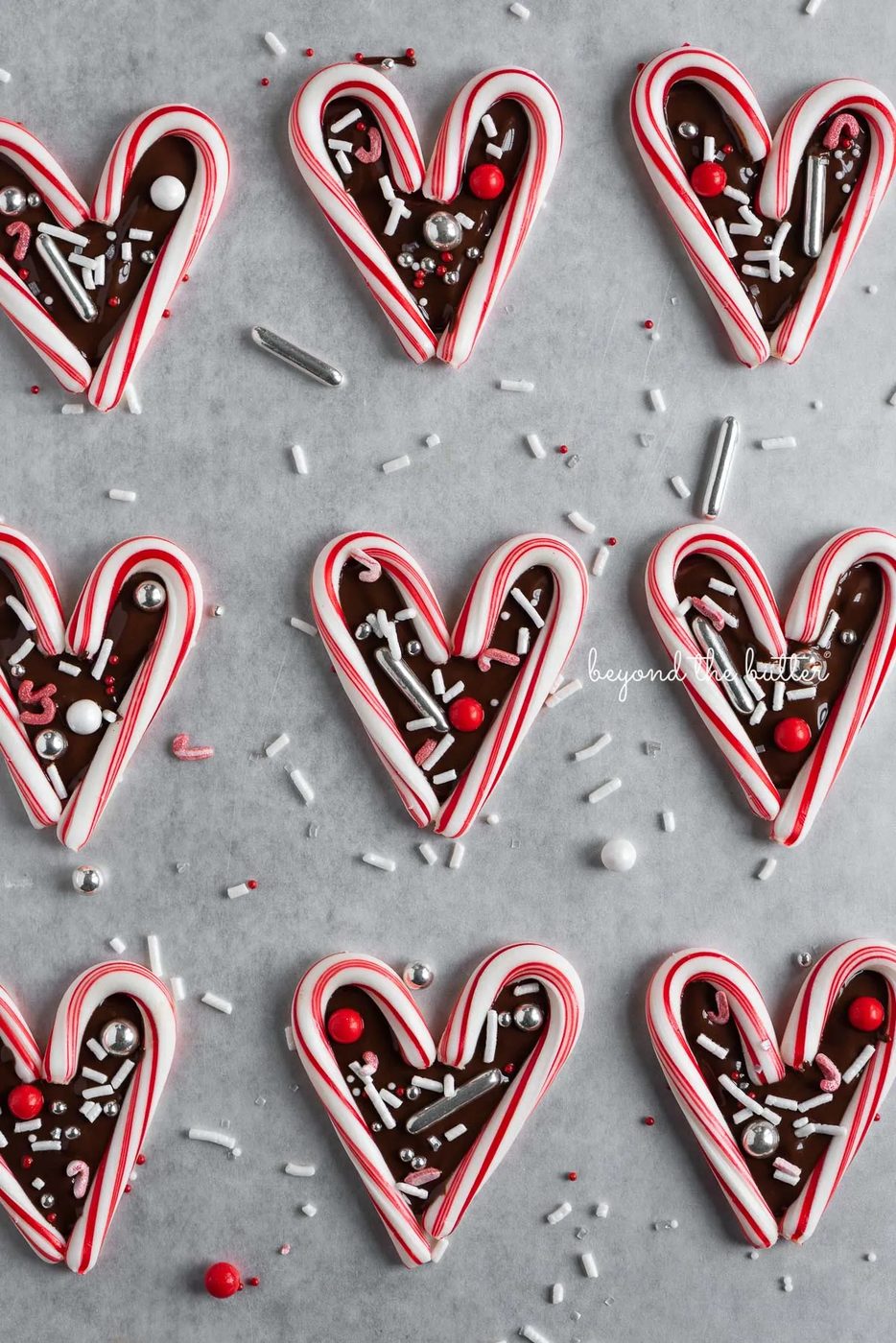 Fun candy cane hearts on parchment paper | © Sovuh