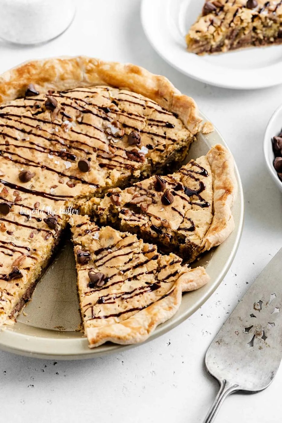 Overhead angled image of chocolate chip pie with 2 slices cut | All Images © Sovuh
