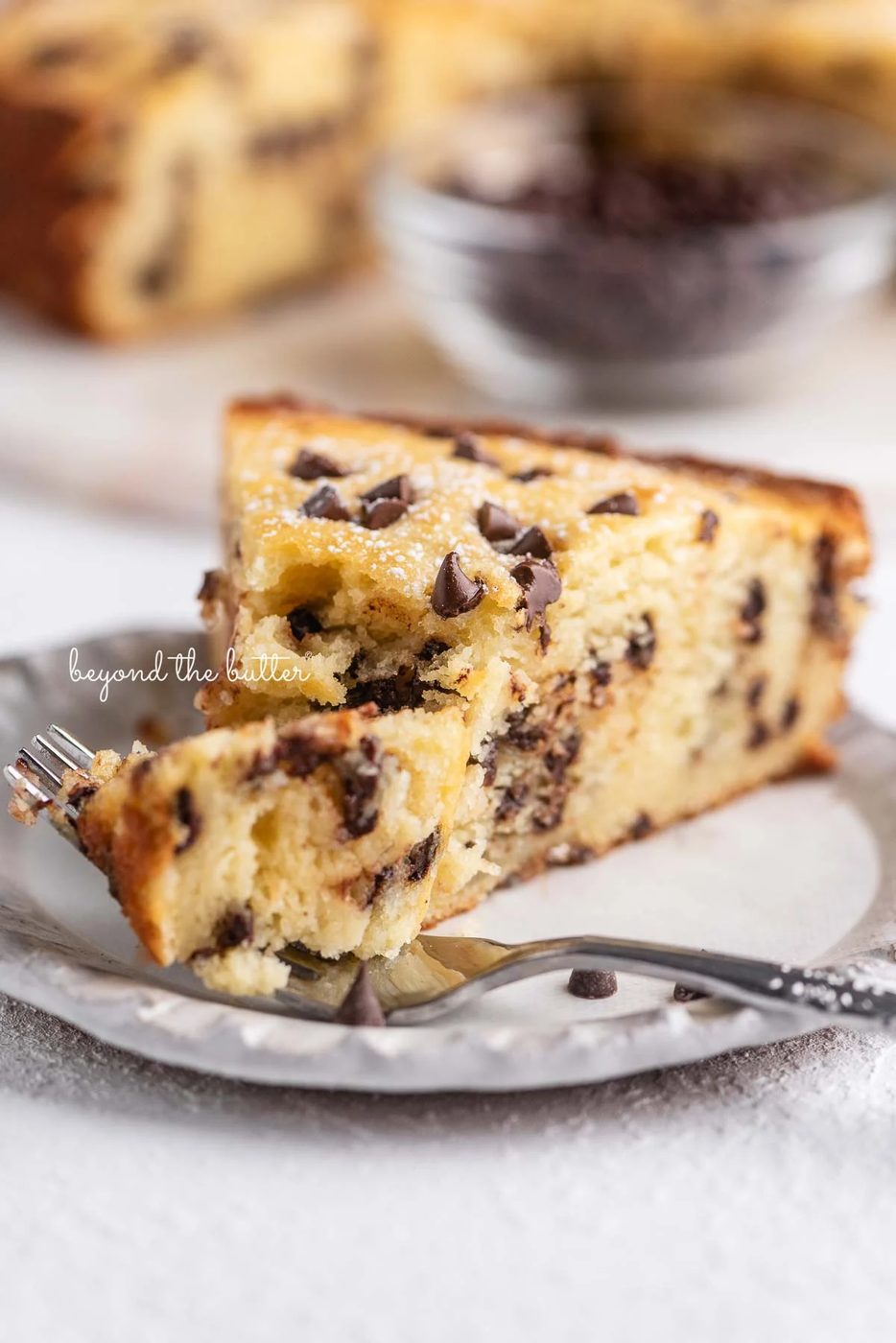 Slice of chocolate chip ricotta cake with a fork holding the first bite | © Sovuh