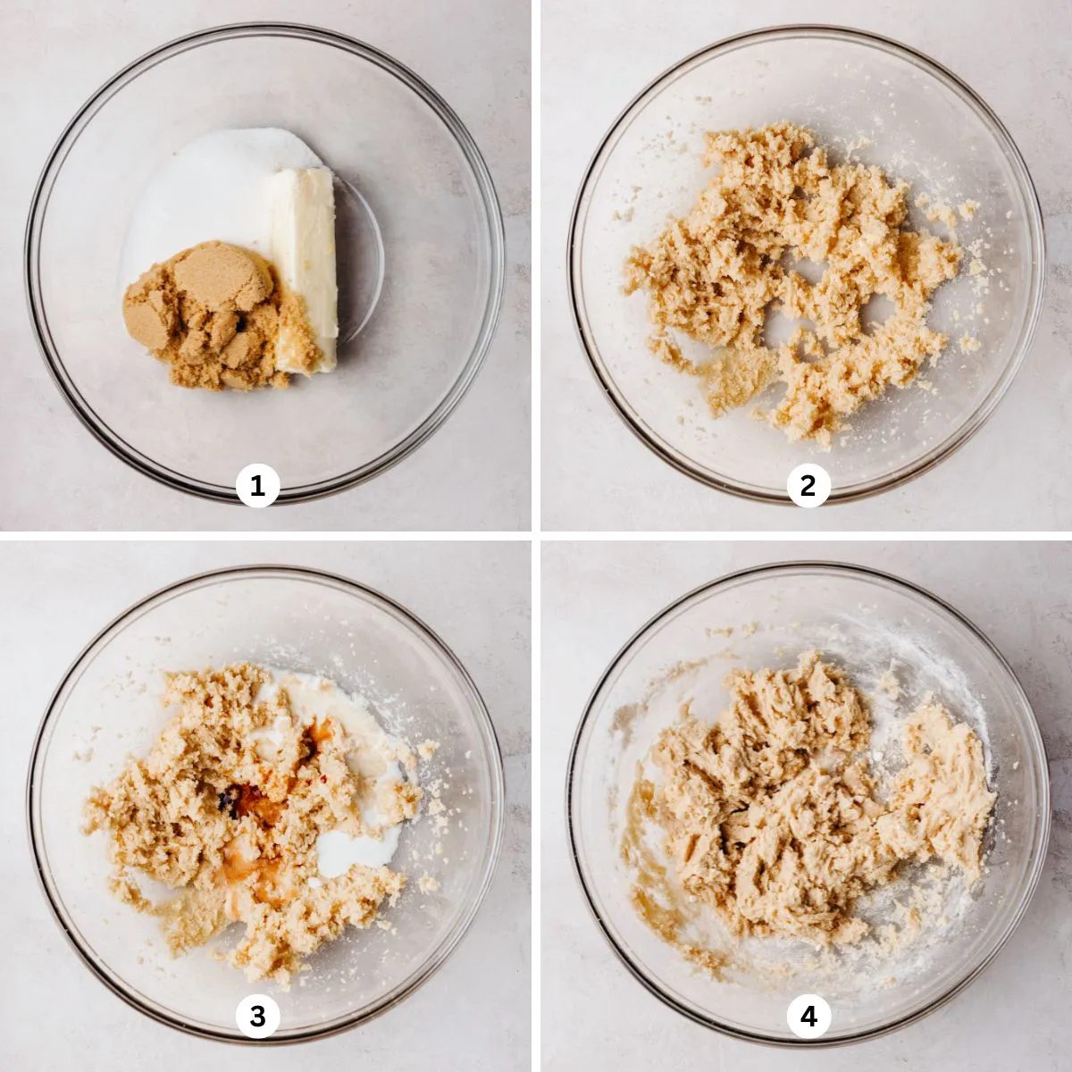 Mixing the butter and sugars together, then adding in the milk and vanilla extract in a glass bowl on a white marbled background.