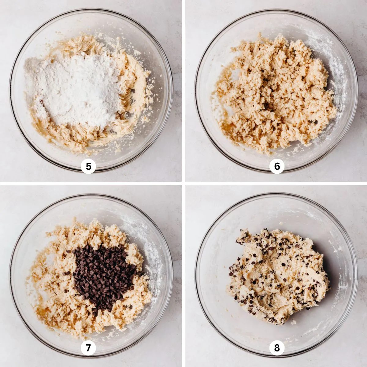 Adding heat treated flour, salt, and mini semi-sweet chocolate chips to the edible cookie dough mixture in a glass bowl on a white marbled background.