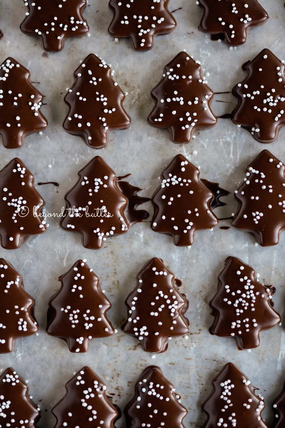 Chocolate Dipped Graham Cracker Chrismtas Trees on a cookie sheet | © Sovuh