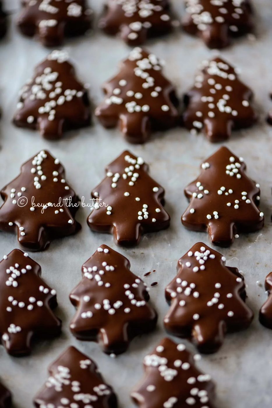 Chocolate Dipped Graham Cracker Chrismtas Trees on a cookie sheet | © Sovuh