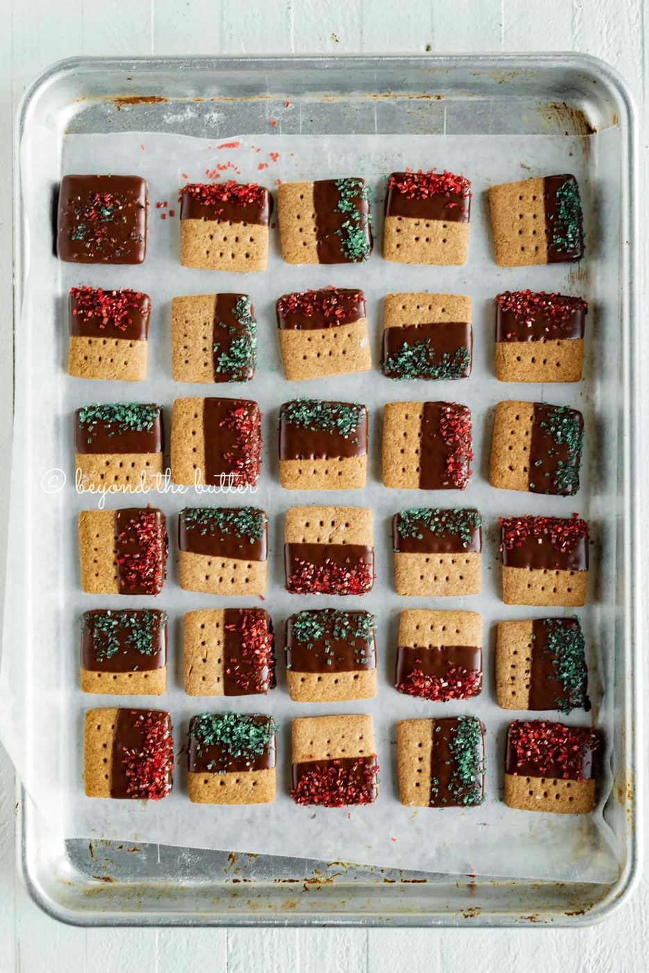 Cookie sheet with rows of Chocolate Dipped Graham Cracker Sqaures | © Sovuh