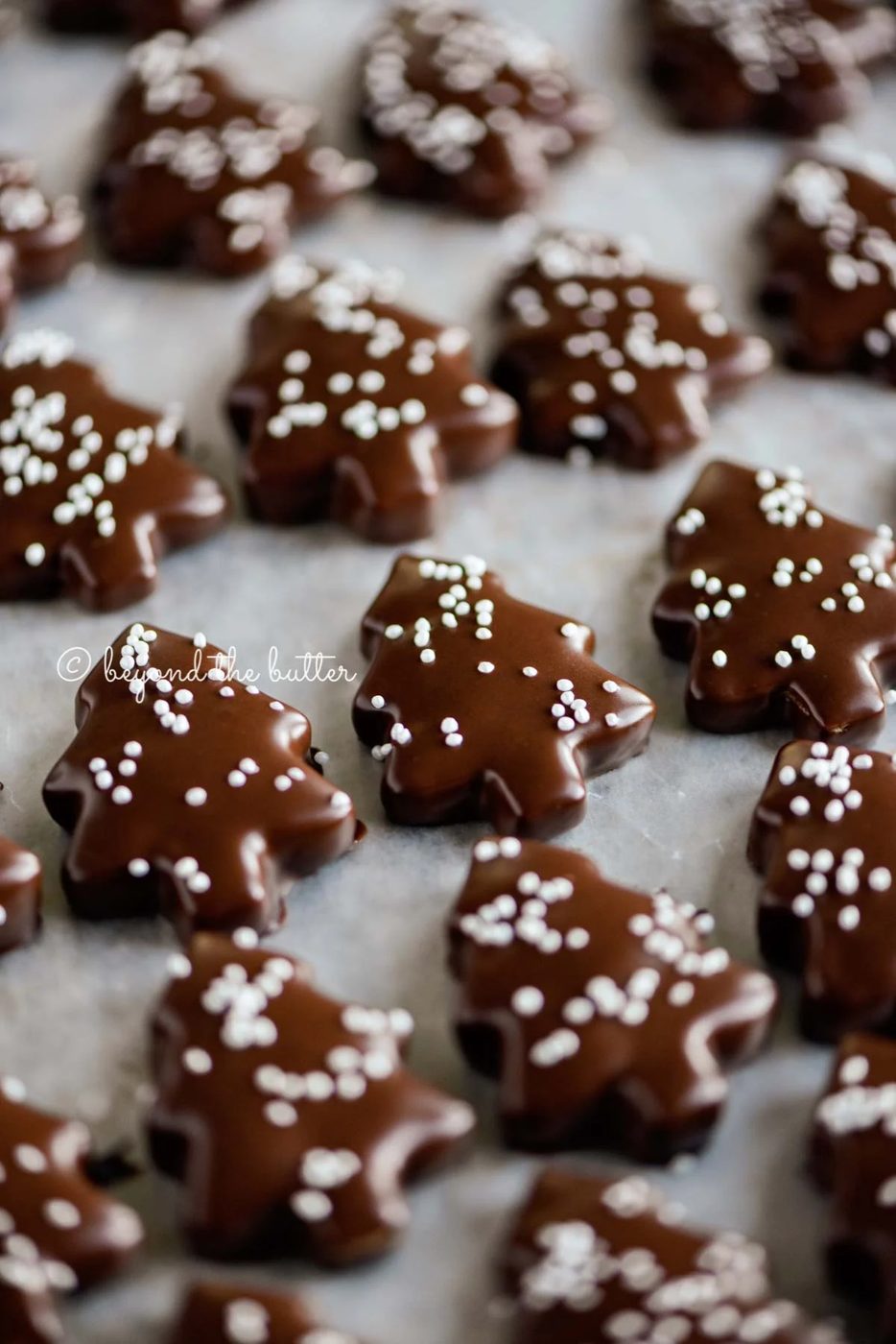 Closeup image of Chocolate Dipped Graham Cracker Chrismtas Trees on a cookie sheet | © Sovuh