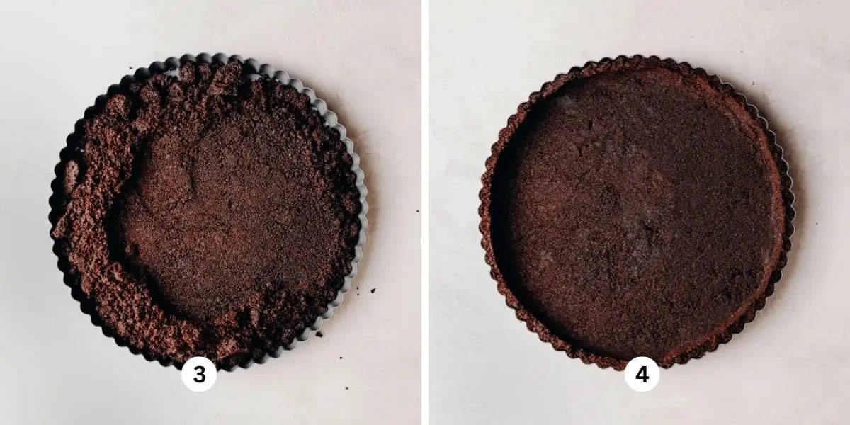 Chocolate cookie crust being pressed into a tart pan placed on a white background.