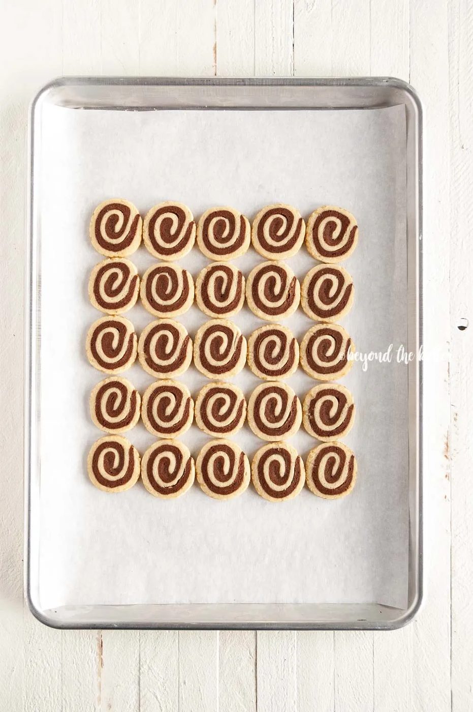 Overhead image of Chocolate Pinwheel Cookies in rows on a baking sheet | All images © Sovuh