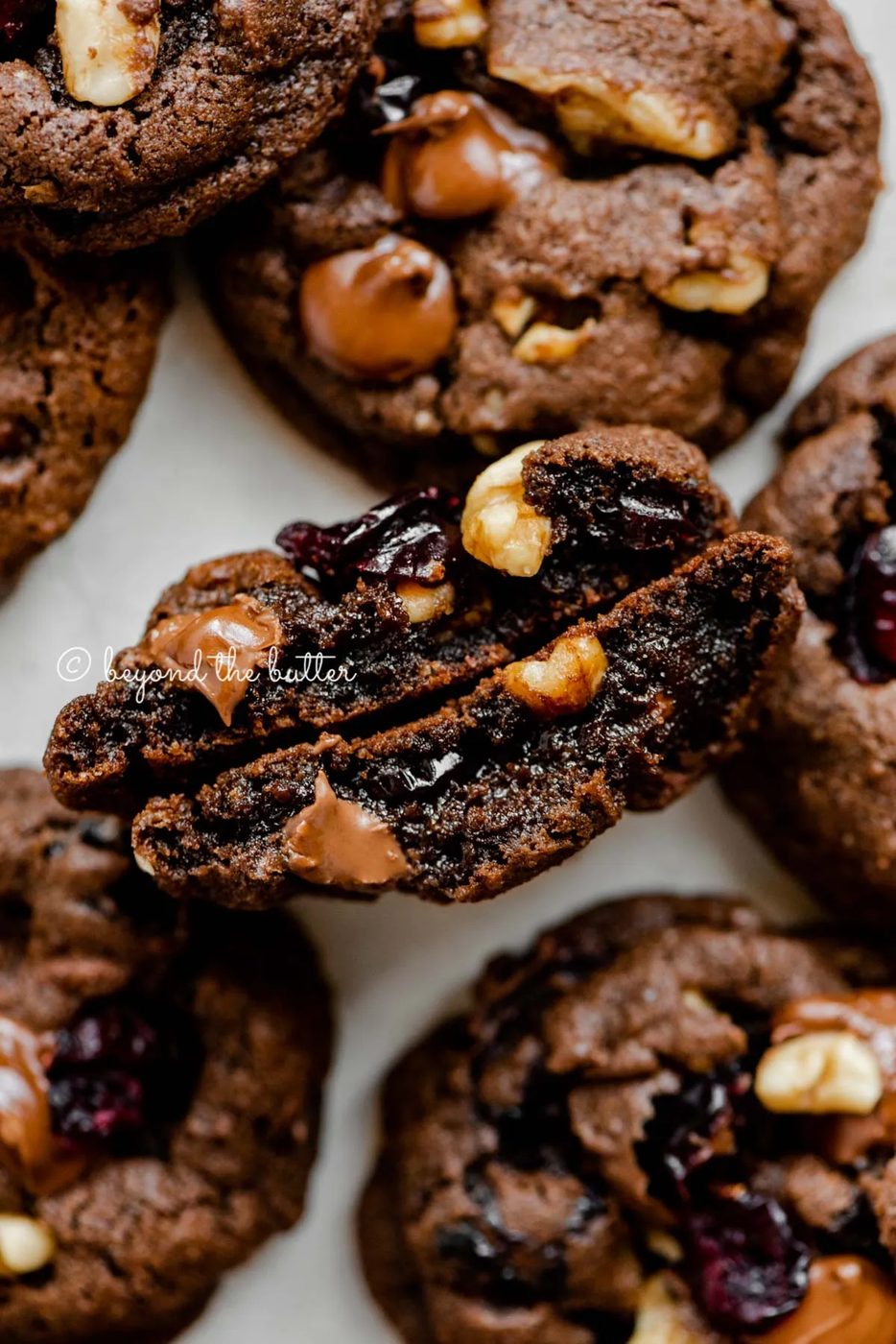 Dark chocolate cranberry walnut cookie split in half to see the inside | All Images © Sovuh