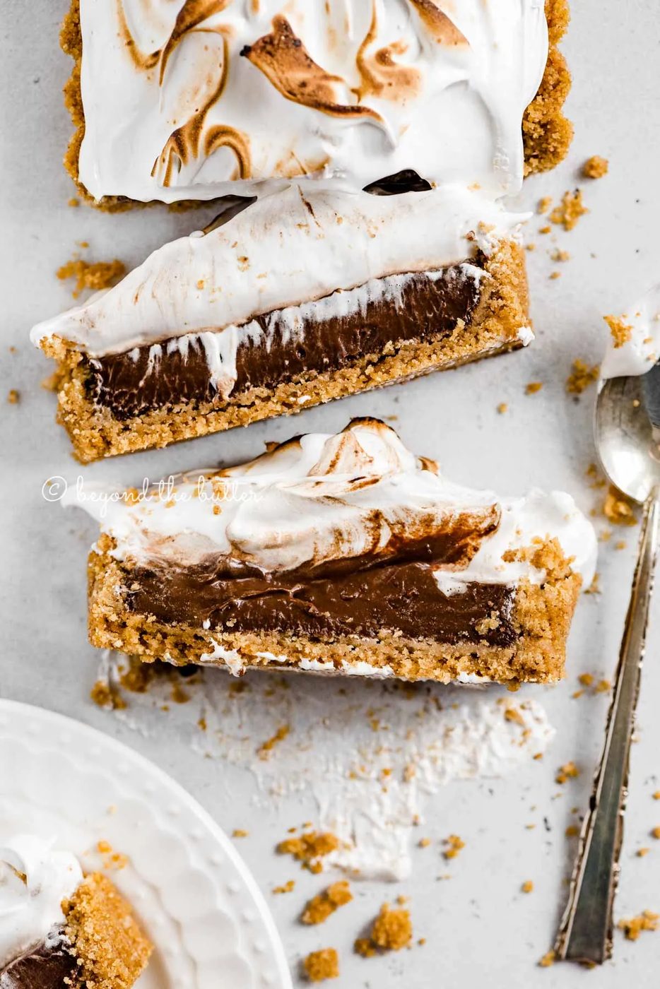 Overhead image of chocolate marshmallow tart with 2 slices cut and laid on their side | All Images © Sovuh
