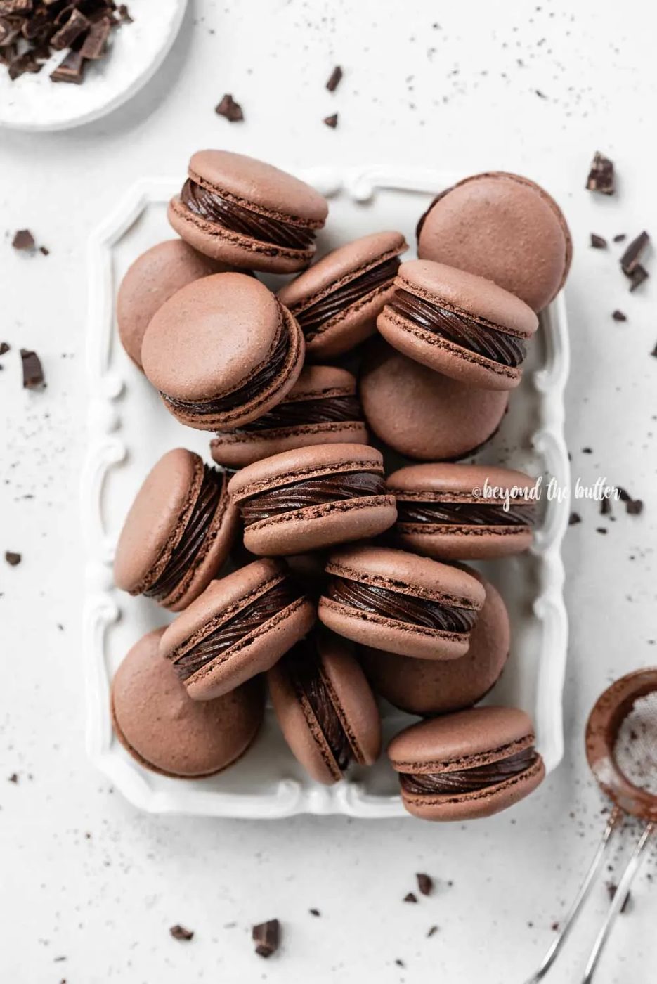 Plate full of dark chocolate macarons | All Images © Sovuh