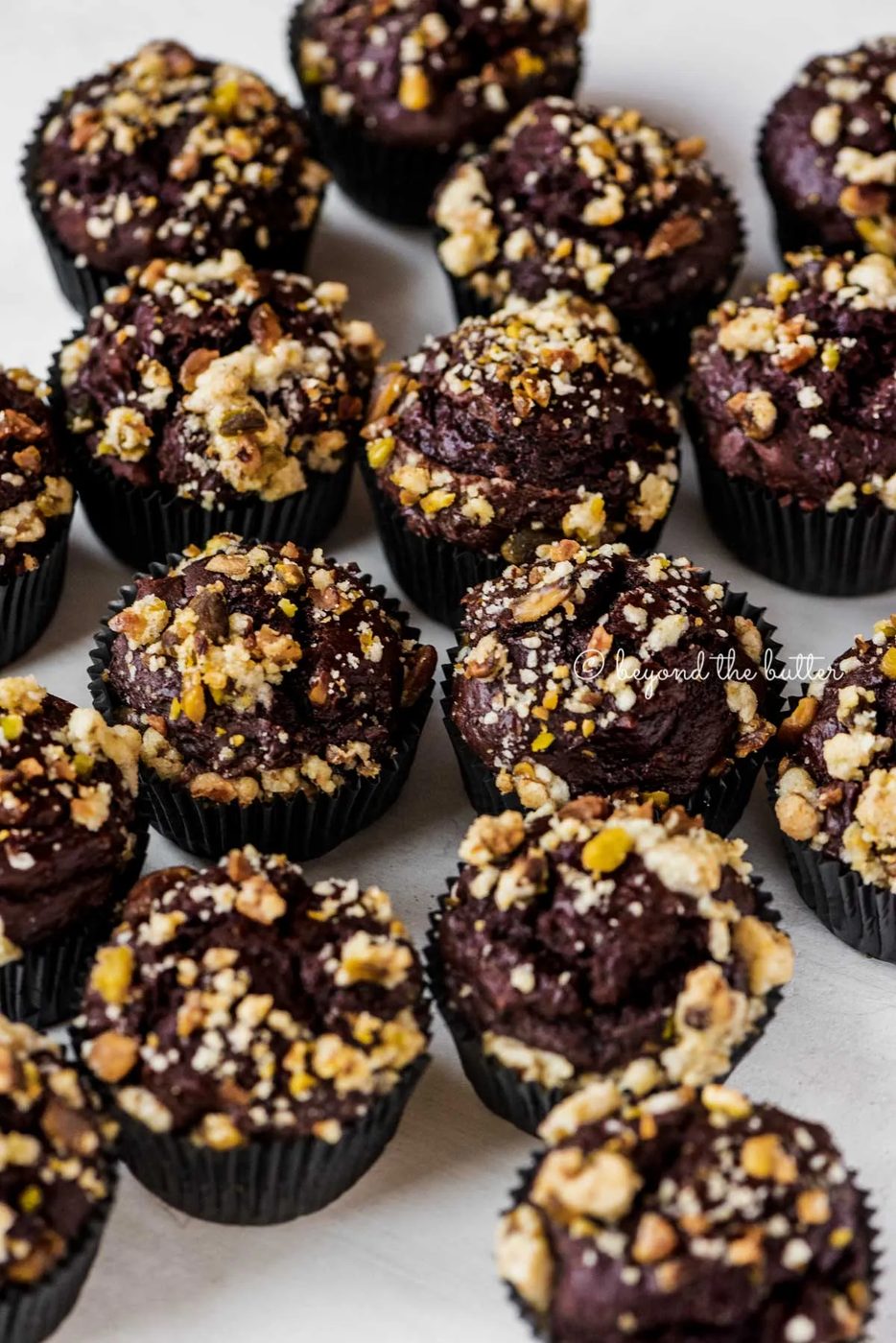 Randomly places dark chocolate pistachio cream cheese muffins on gray background | All Images © Sovuh