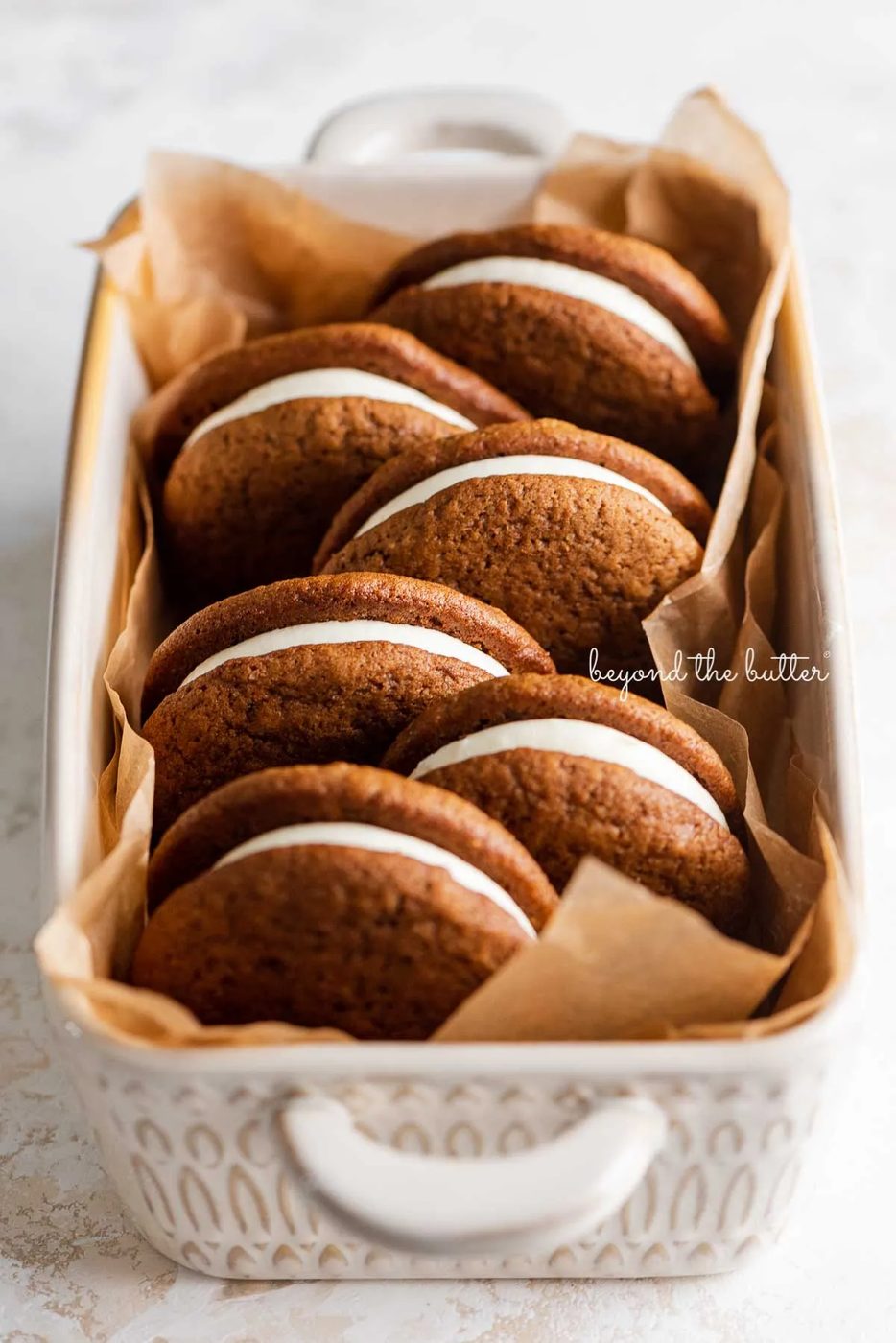 Natural parchment paper lined ceramic baking pan with house-made gingerbread whoopie pies | © Sovuh