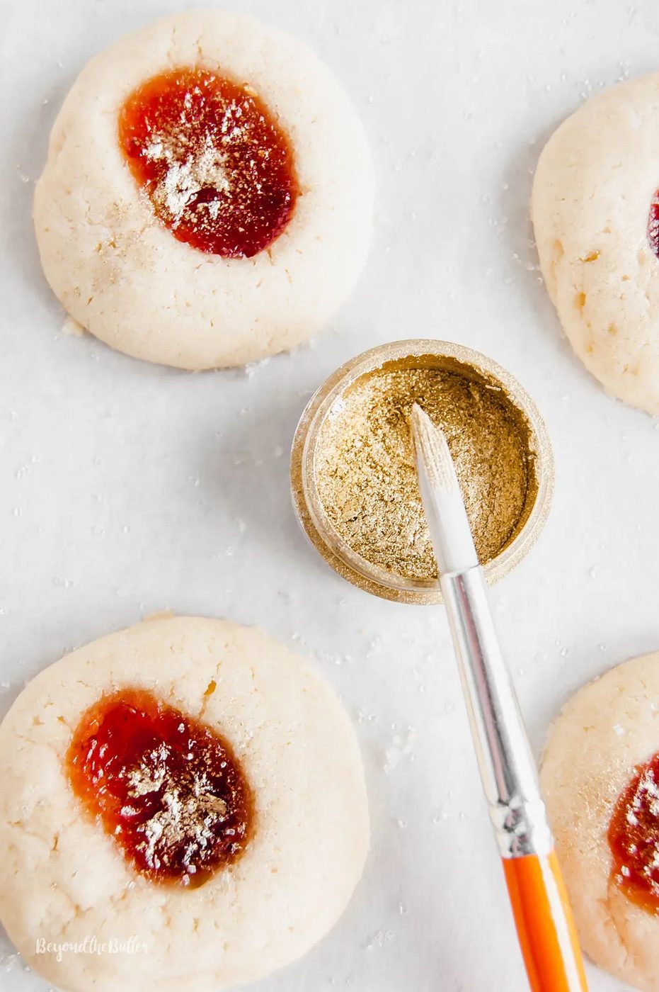 Holiday Jamboree Cookies - jamboree cookies being sprinkled with gold using a brush