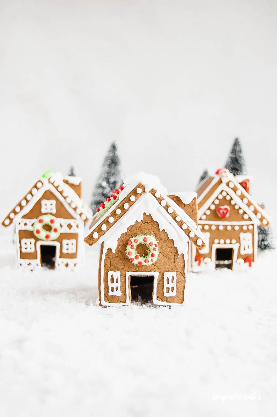 House-made Gingerbread Houses - 3 gingerbread houses with trees in the background | All Images © Sovuh, LLC
