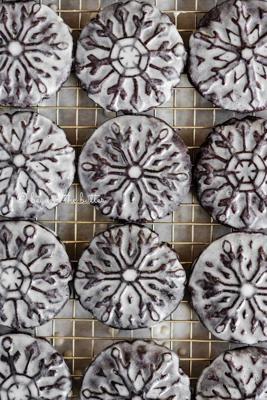Overhead image of house-made oreo snowflake cookies on a wire cooling rack | All Images © Sovuh