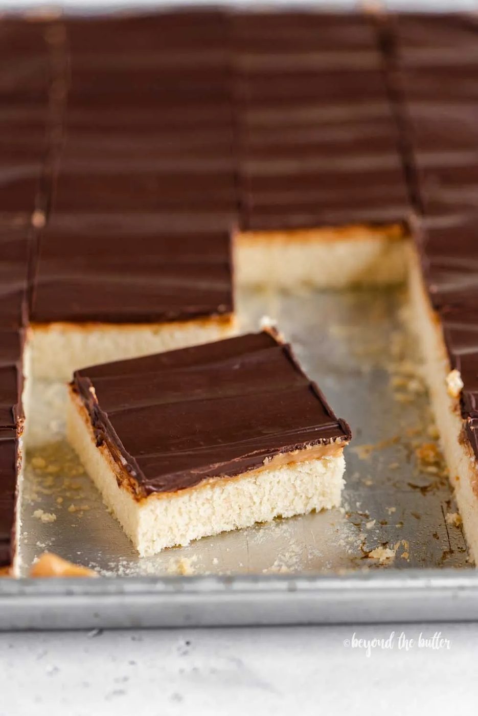 Angled image of cut irresistible peanut butter tandy kakes with one angled out from the rest | All Images © Sovuh