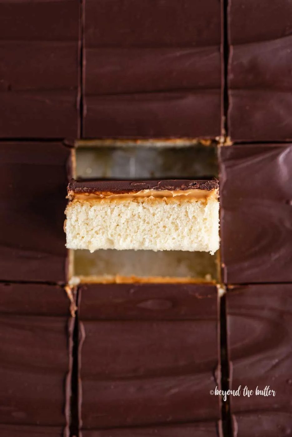 Closeup overhead image of cut irresistible peanut butter tandy kakes with one showing the side view | All Images © Sovuh