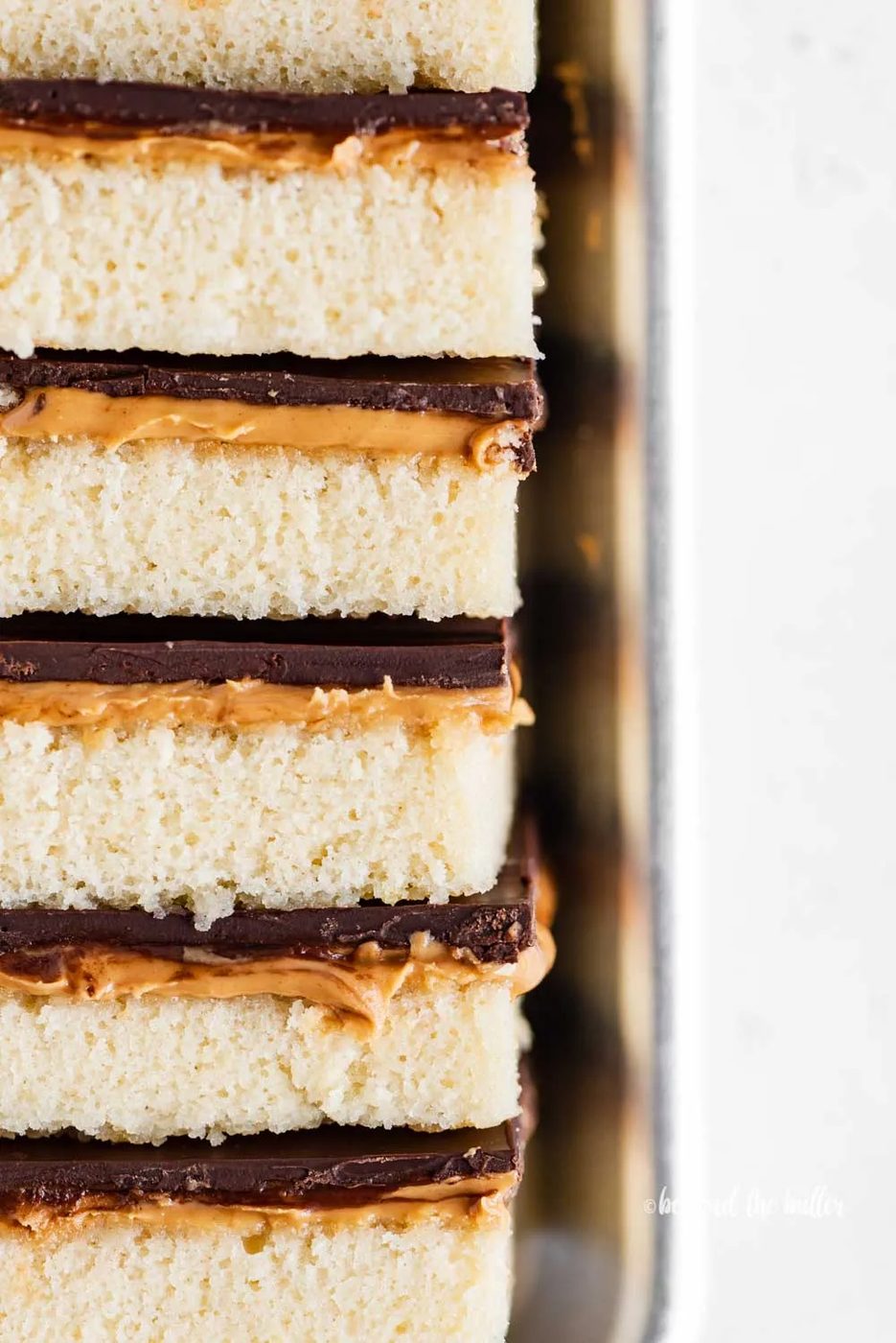 Closeup image of stacked house-made peanut butter kandy kakes on baking sheet | All Images © Sovuh