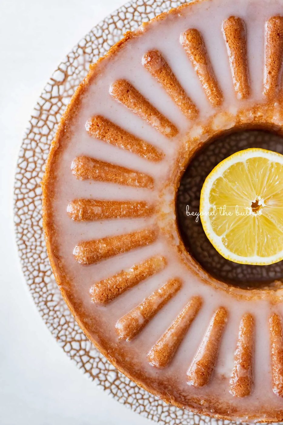 Glazed lemon cream cheese pound cake on a ceramic cake stand from Sweetheart Ceramics | © Sovuh