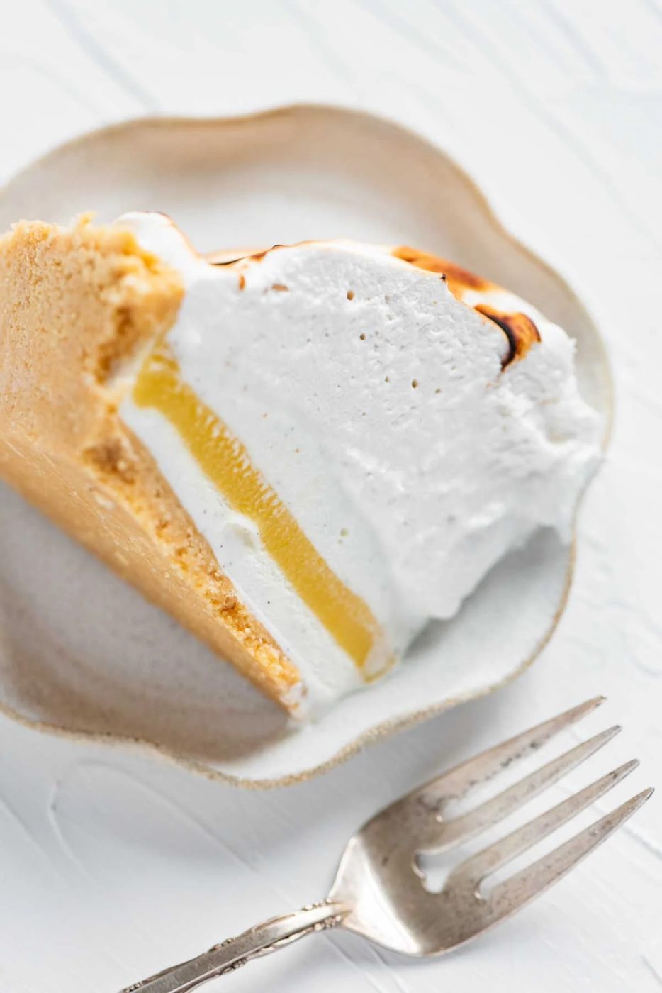 Slice of lemon meringue ice cream pie on its side from Sovuh.com | © Sovuh