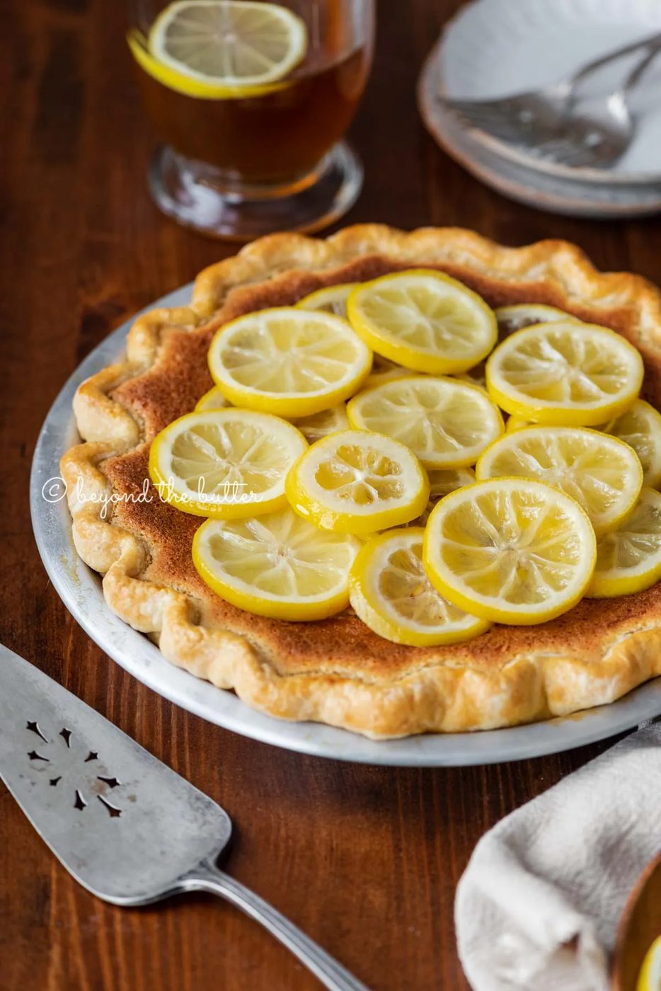 lemon sponge pie on a dark wood dining room table with hot lemon tea | All images © Sovuh