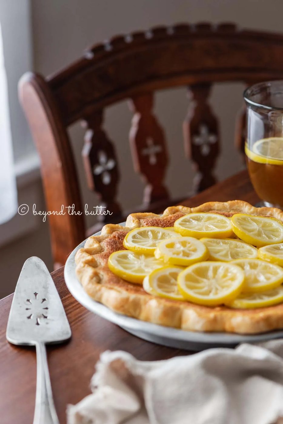 lemon sponge pie on a dark wood dining room table with hot lemon tea | All images © Sovuh