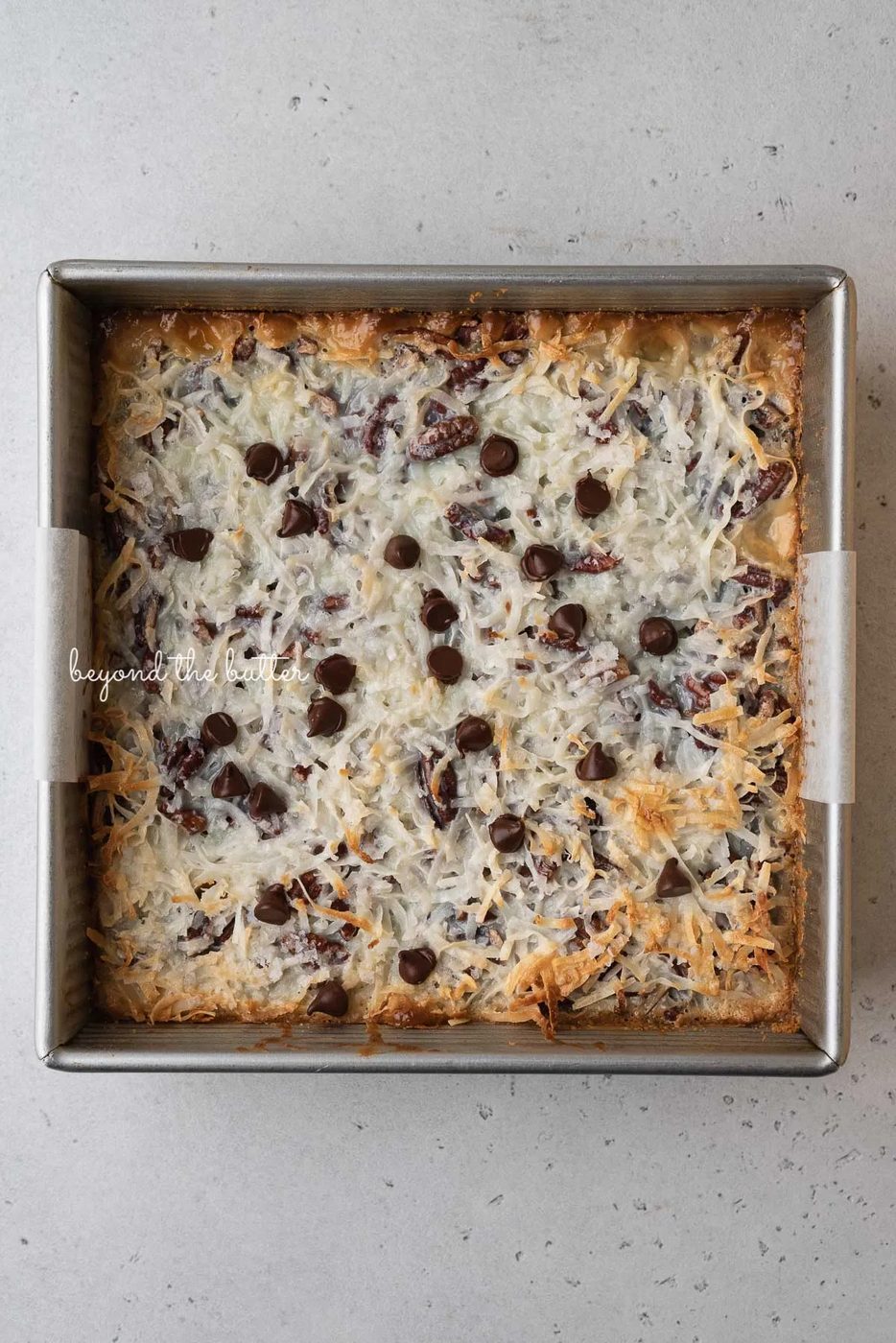 Just baked 7 layer magic cookie bars in 8 inch baking pan | © Sovuh