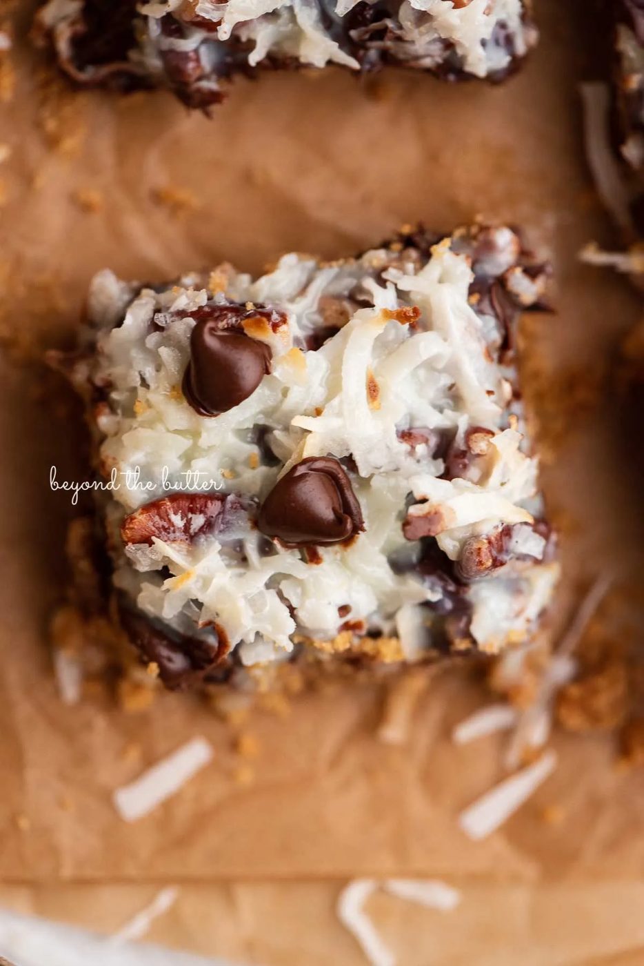 Magic cookie bars on brown parchment paper | © Sovuh