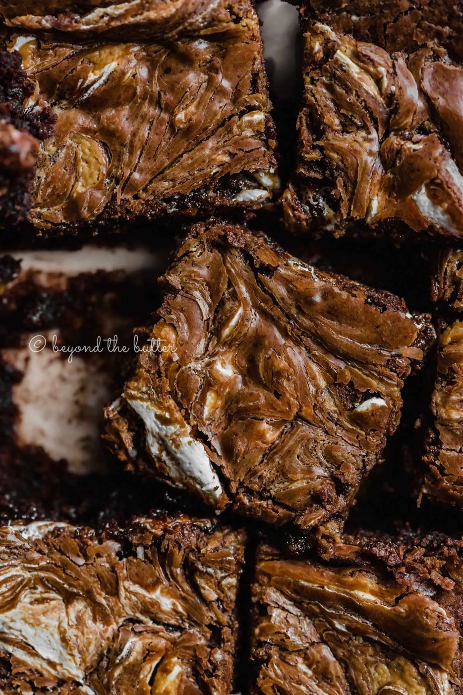 Closeup of randomly placed marshmallow peanut butter brownies on parchment paper | All Images © Sovuh