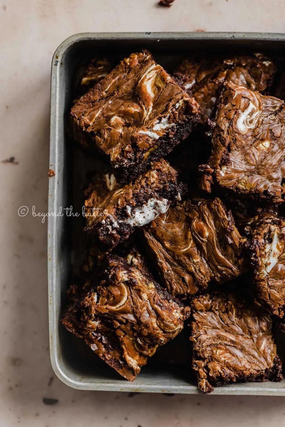 Closeup of randomly placed marshmallow peanut butter brownies in small baking tray | All Images © Sovuh