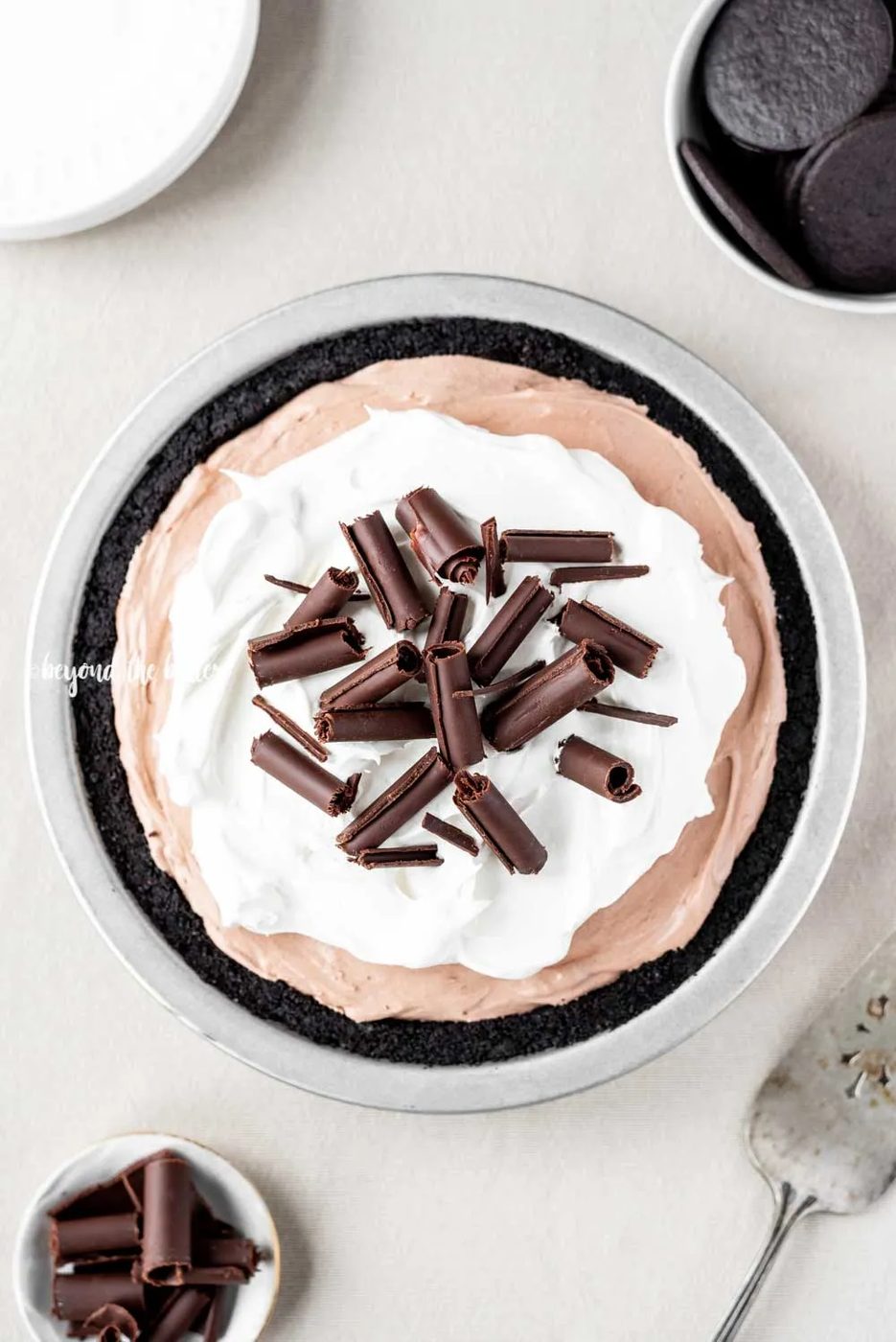 Overhead image of No-Bake Chocolate Cream Pie garnished with Cool Whip and chocolate curls | All Images © Sovuh