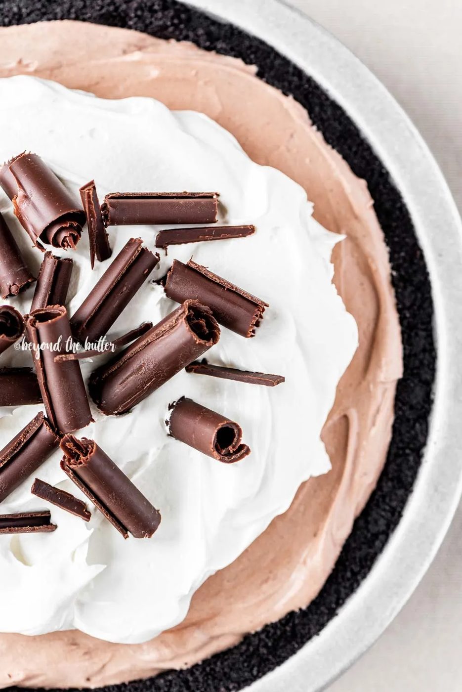 Overhead image of No-Bake Chocolate Cream Pie garnished with Cool Whip and chocolate curls | All Images © Sovuh