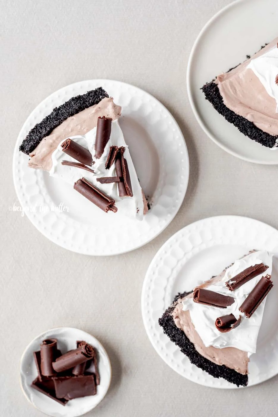 Slices of no-bake chocolate cream pie with chocolate wafer crust on dessert plates | All Images © Sovuh