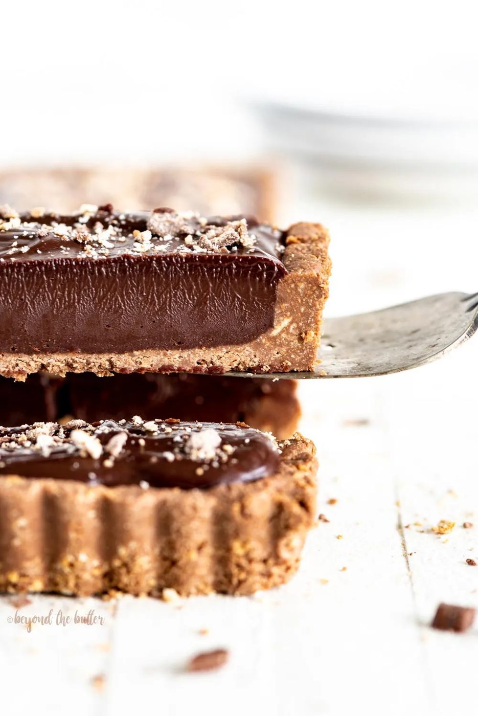 No-bake Dark Chocolate Tart | Close-up photo of a slice of no-bake dark chocolate tart being lifted up with a serving utensil | Image and Copyright Policy: © Sovuh, LLC