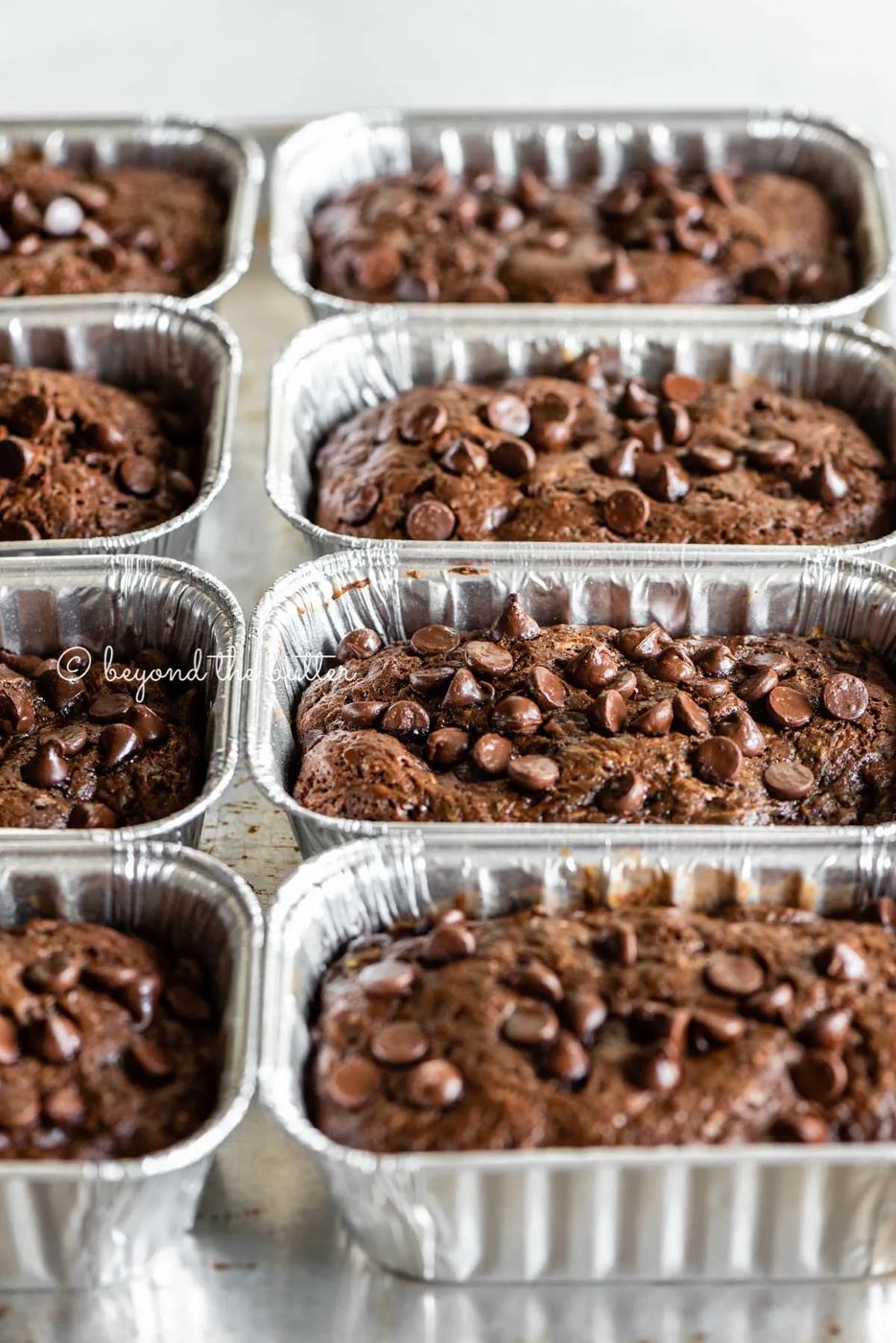 Angled image of mini chocolate zucchini bread loaves | All Images © Sovuh