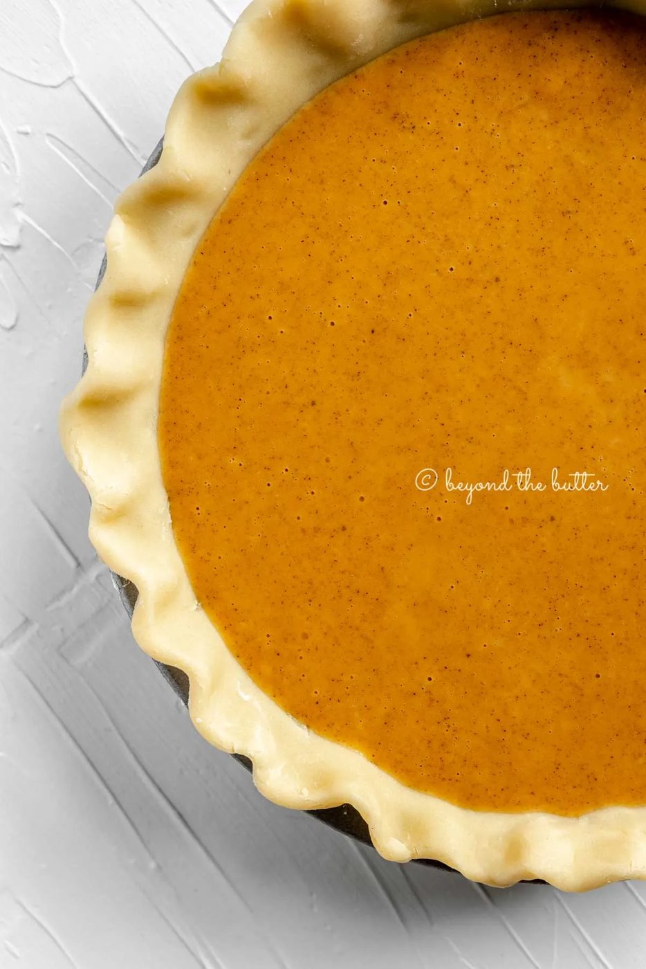 Unbaked pumpkin pie ready for the oven | All Images © Sovuh