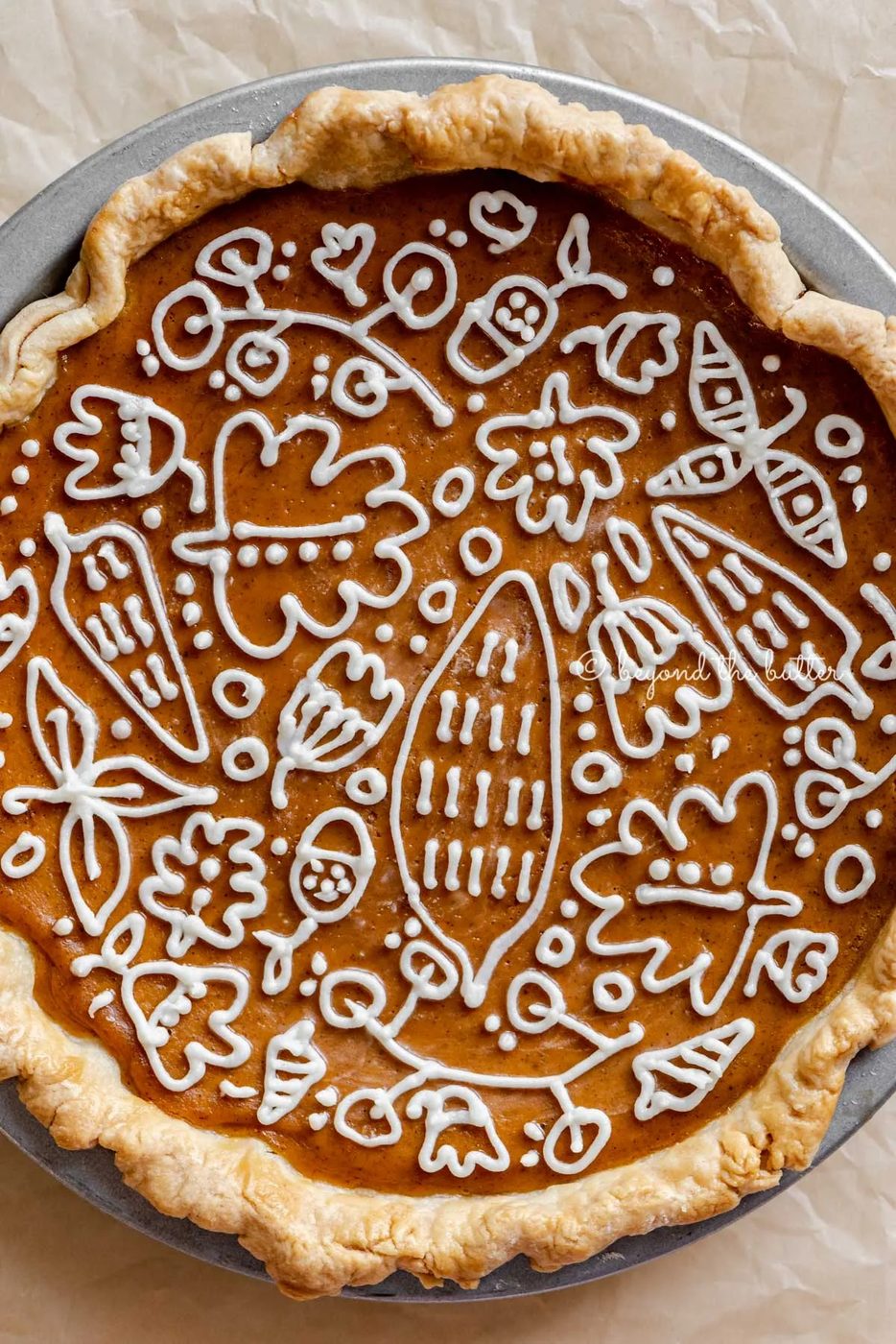 Overhead close up image of perfect pumpkin pie with cream cheese frosting piped decorative top | All Images © Sovuh