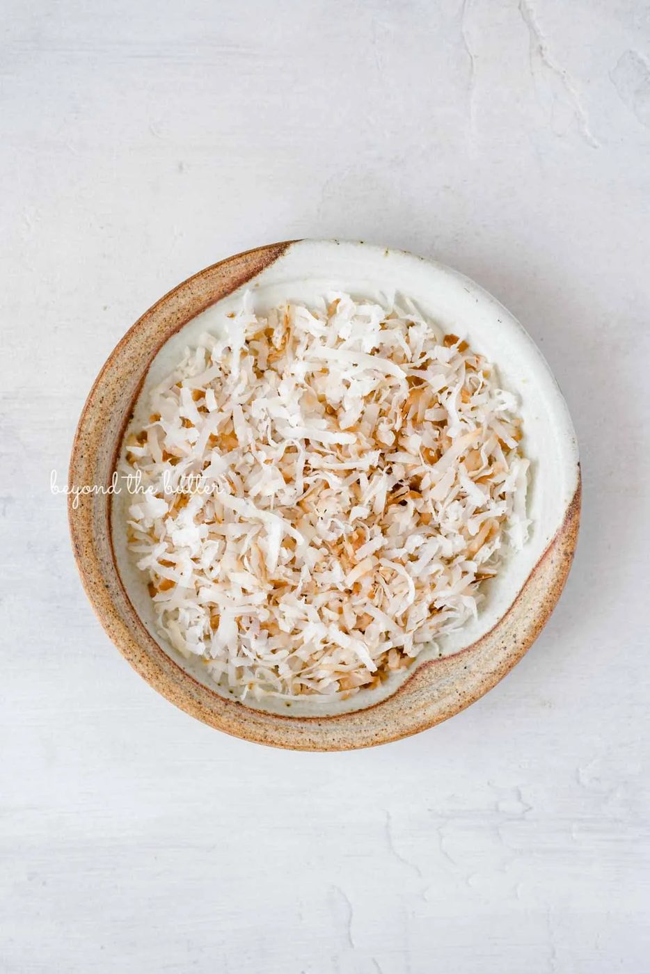Toasted coconut flakes used as a flavorful enter in this Robin's Egg Macarons recipe | All images © Sovuh