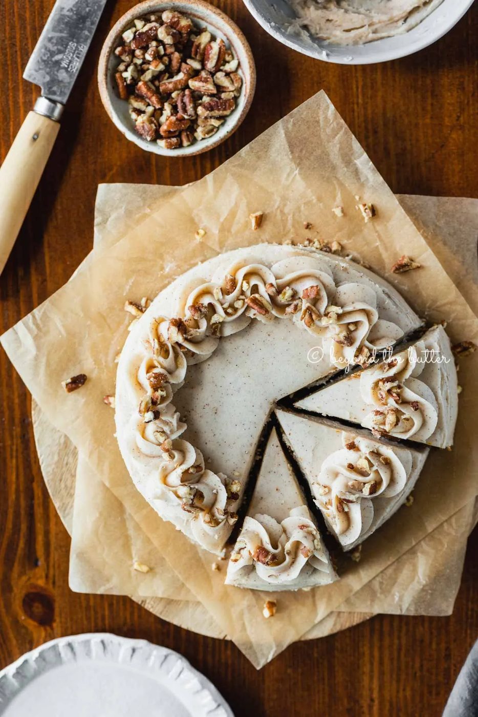 Overhead image of sliced 6 inch single layer carrot cake on parchment paper | All Images © Sovuh