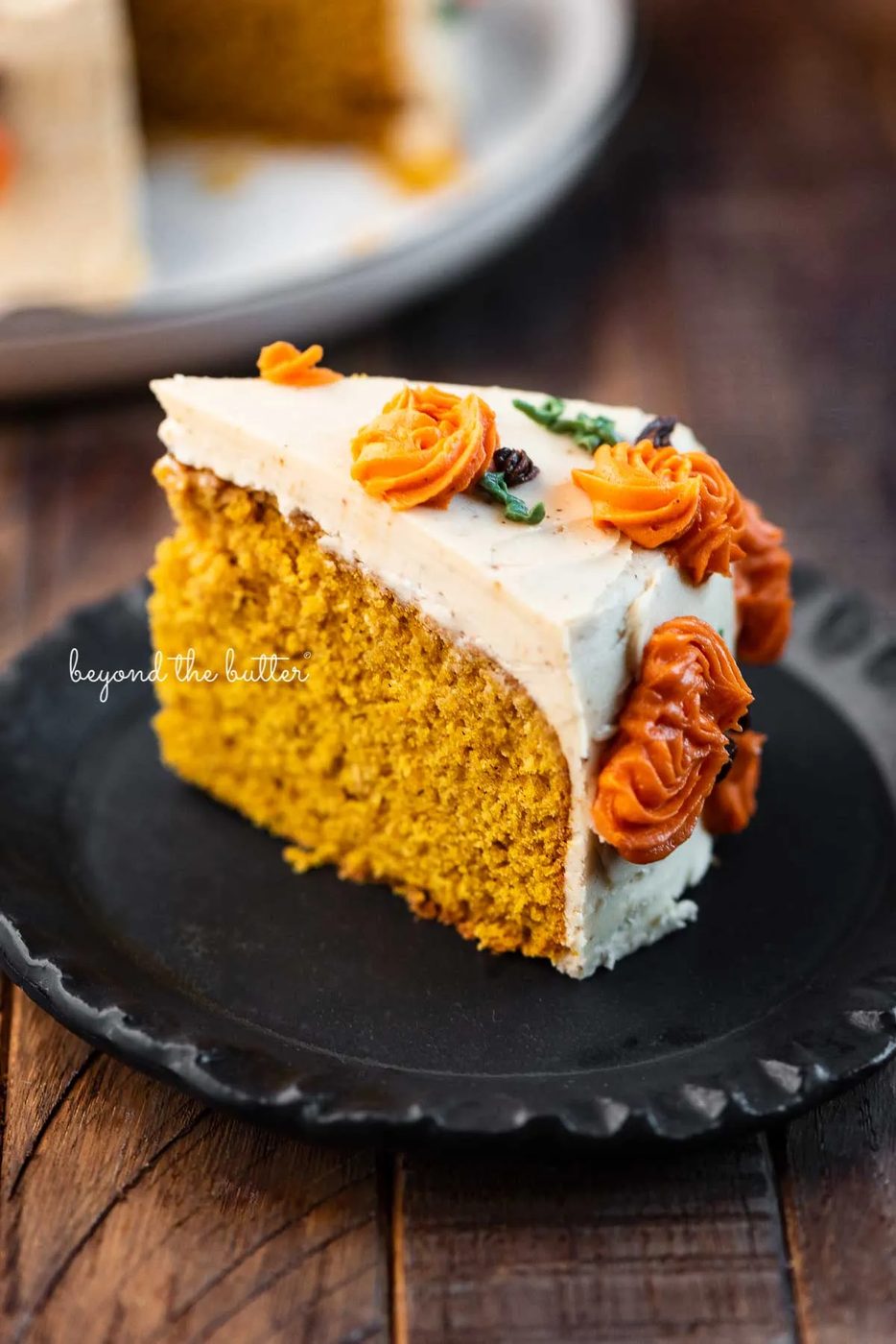 Slice of pumpkin spice cake on a small black dessert plate | © Sovuh