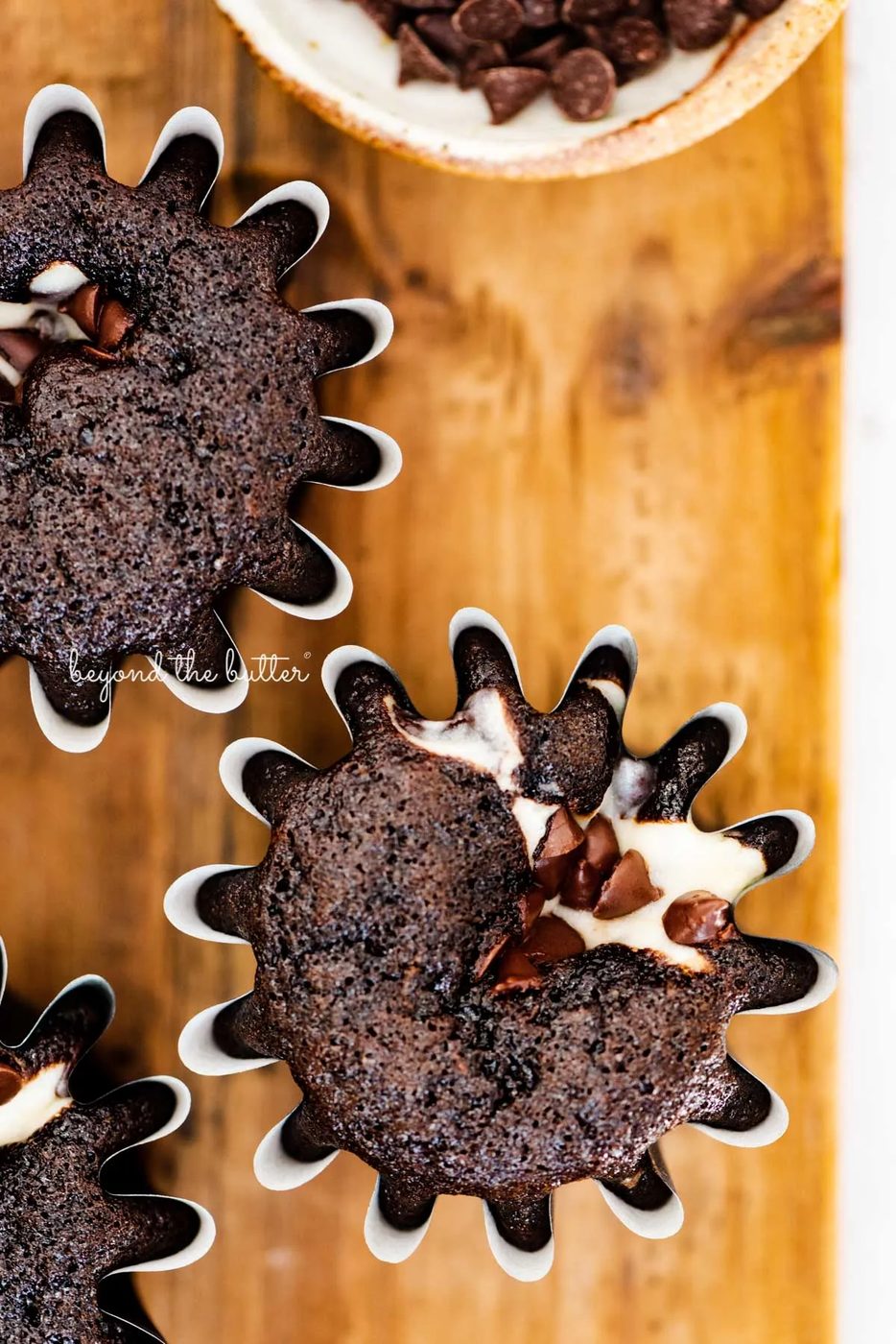 Small batch black bottom cupcakes on a wood cutting board | © Sovuh