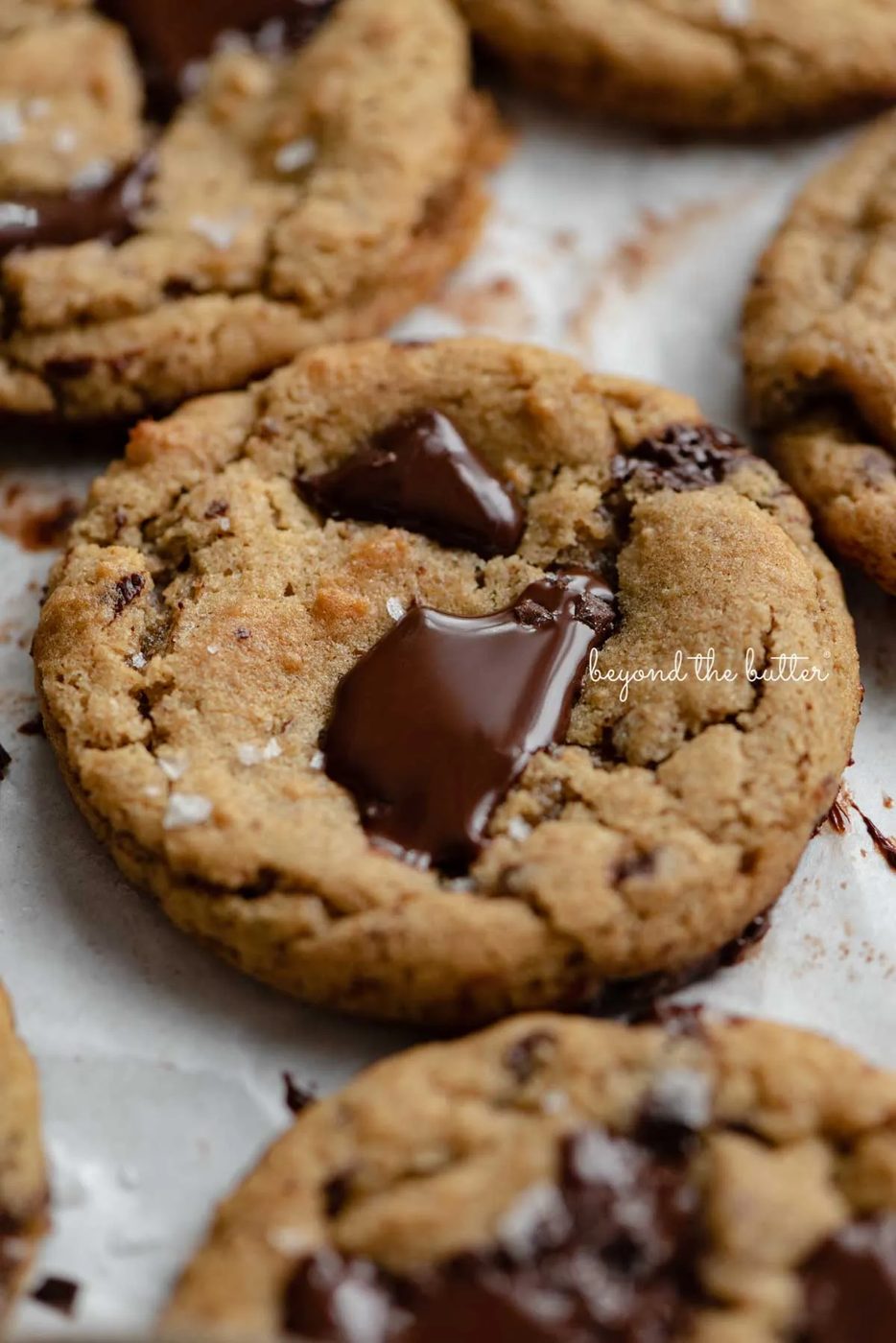 Small batch gluten-free peanut butter chocolate chunk cookies on a parchment paper lined baking sheet | © Sovuh