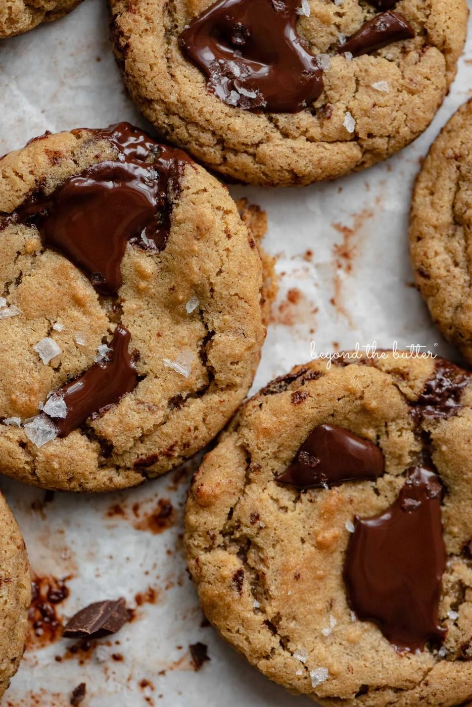 Small batch gluten-free peanut butter chocolate chunk cookies on a parchment paper lined baking sheet | © Sovuh