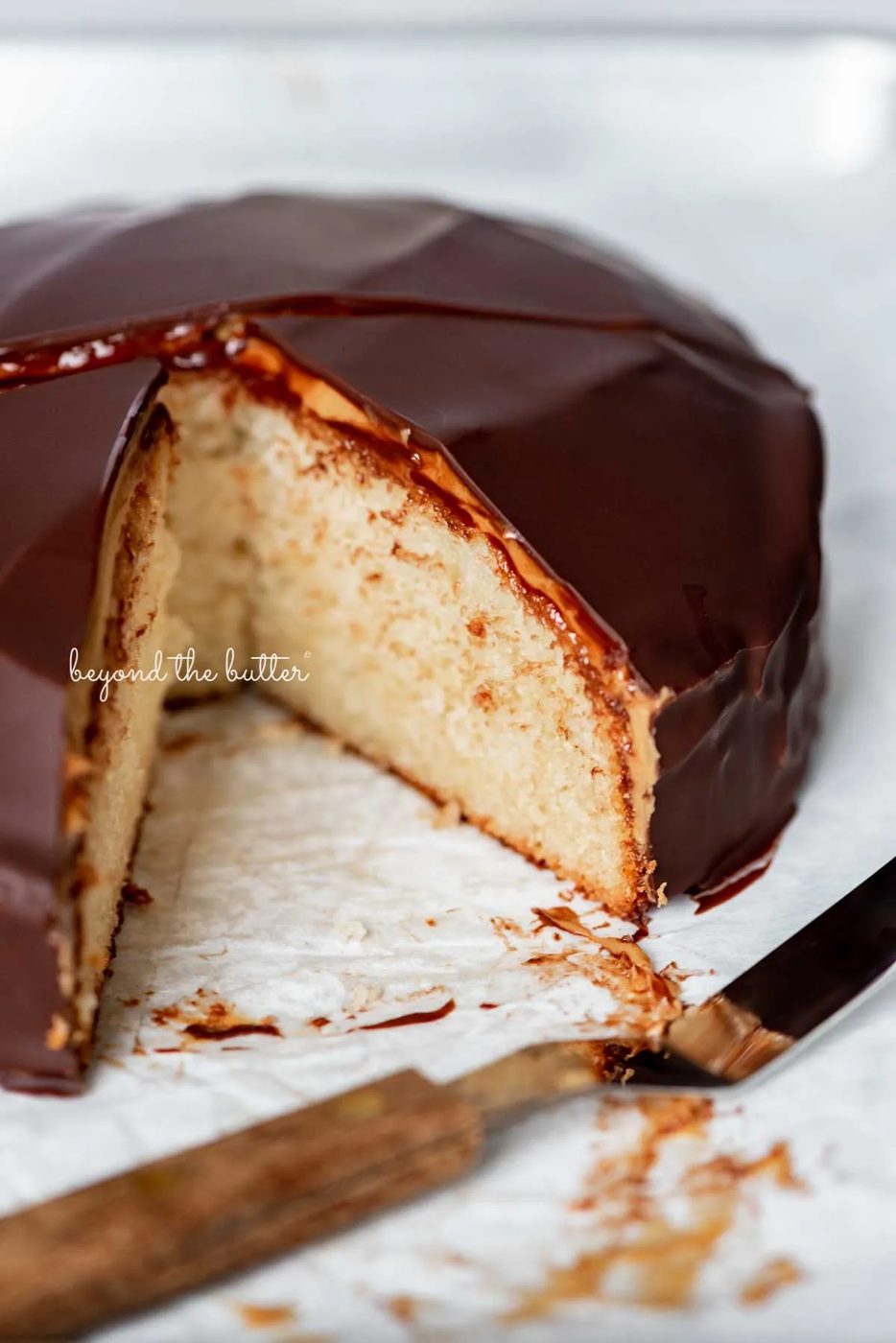 Sliced chocolate peanut butter tandy kake on a parchment paper lined baking sheet | © Sovuh