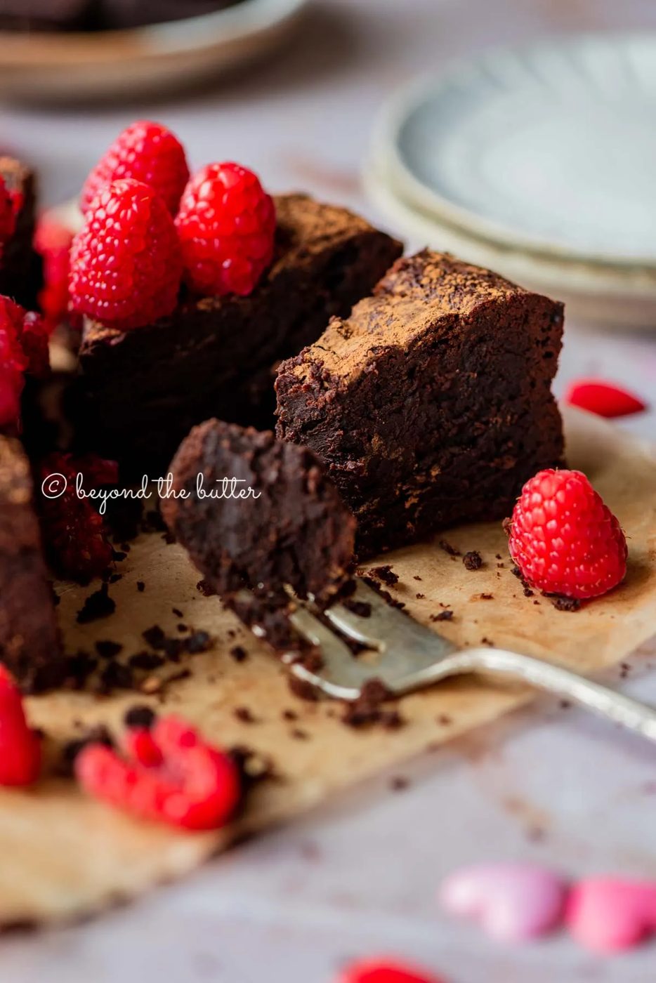 Partially eaten small flourless chocolate cake with fork on parchment paper | All images © Sovuh