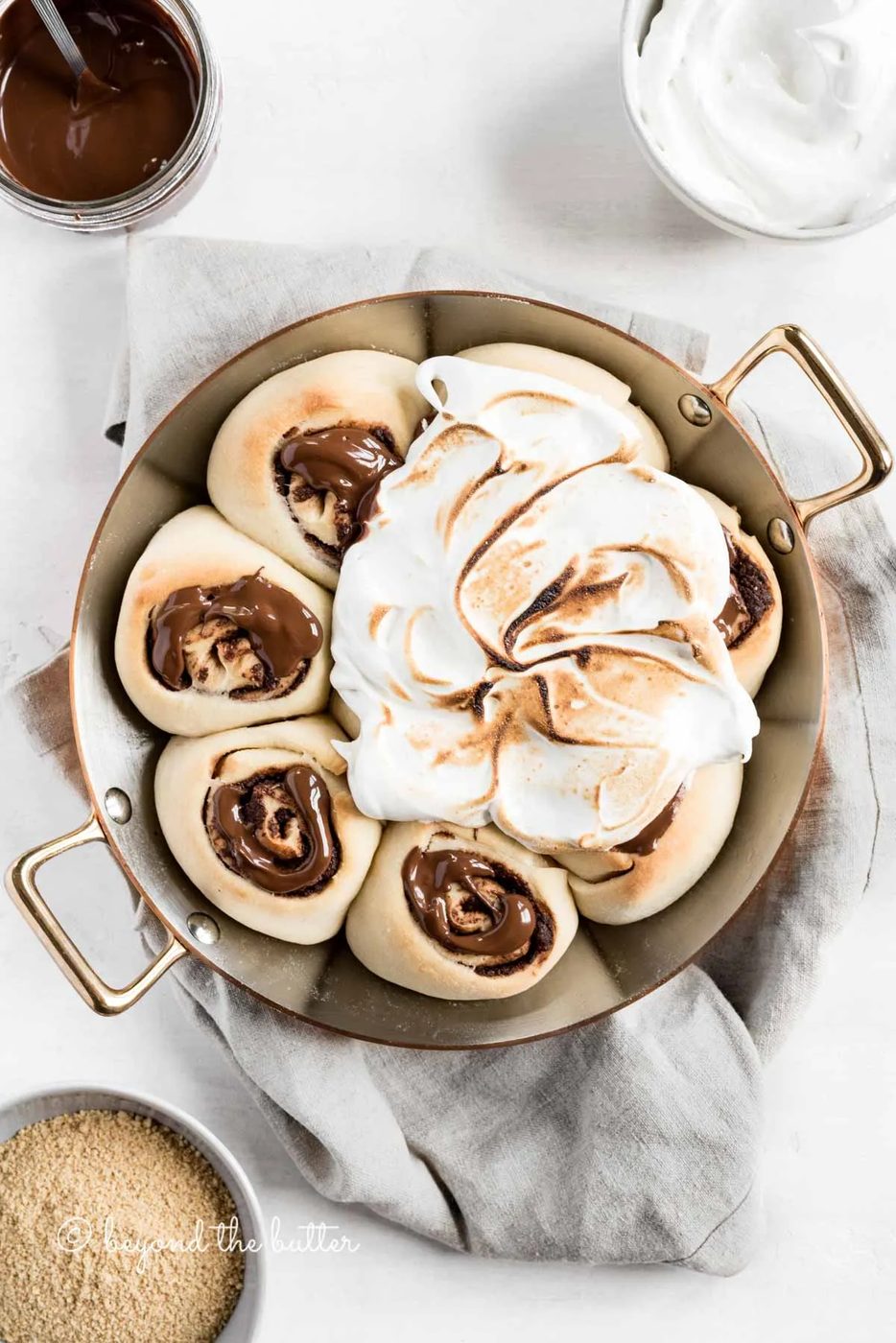 Overhead image of s'mores rolls partially covered with marshmallow topping | All Images © Sovuh